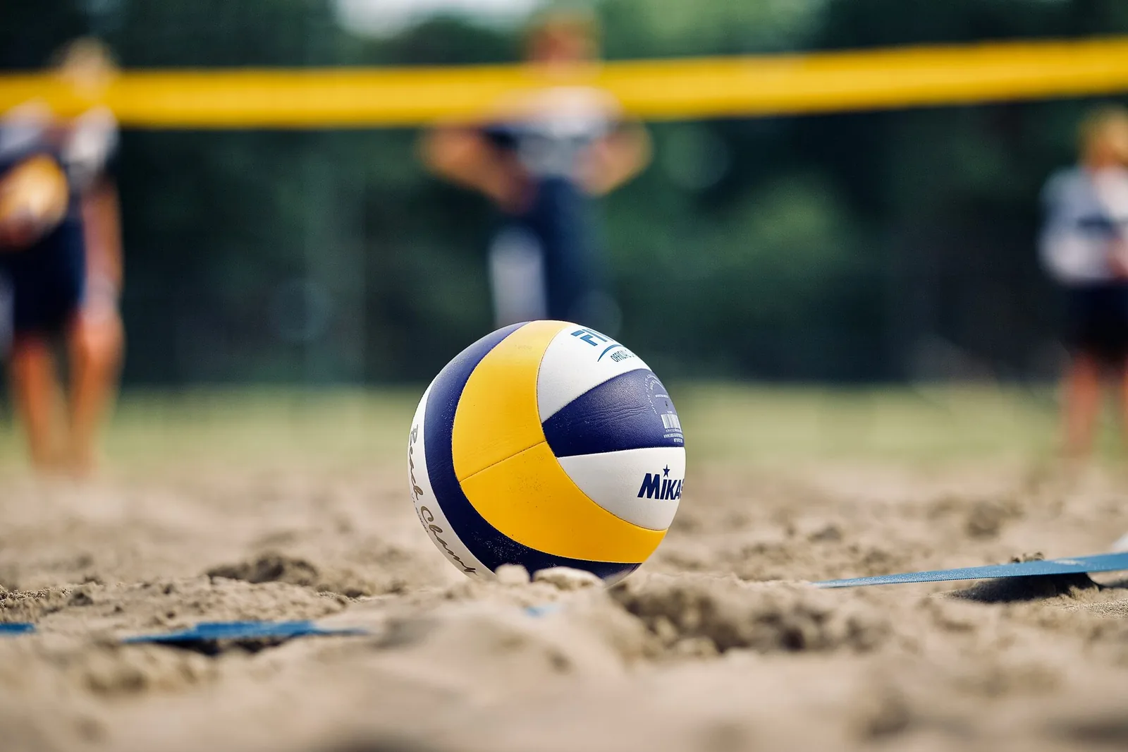 Volleyball resting on sand